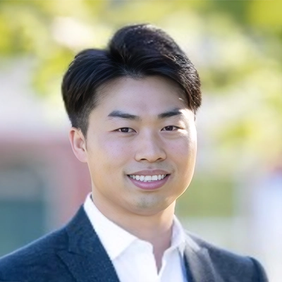 Dentist Henry Hur Smiling Outdoors In Front Of Blurred Background