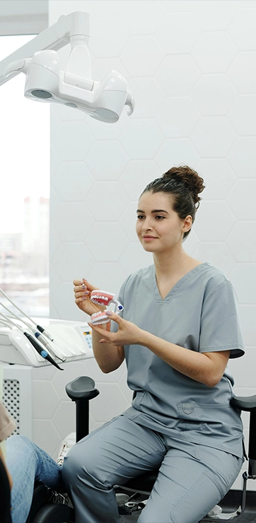 Dental Hygienist With Patient In Exam Room Setting